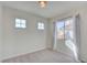 Bright bedroom with neutral walls and carpet flooring, featuring a large window at 8466 Lambert Dr, Las Vegas, NV 89147