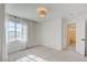 Light-filled bedroom with window, door to en-suite bathroom, and carpet at 8466 Lambert Dr, Las Vegas, NV 89147