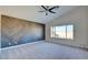 Large bedroom with wood-look accent wall and ceiling fan at 8466 Lambert Dr, Las Vegas, NV 89147