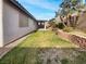 Landscaped backyard with grassy area and retaining wall at 866 Austin Peak Ct, Las Vegas, NV 89110