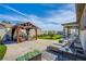 Relaxing backyard with pergola, lawn, and lounge chairs at 8965 S Tenaya Way, Las Vegas, NV 89113