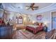 Bedroom with hardwood floors, a large bed, and built-in shelving at 8965 S Tenaya Way, Las Vegas, NV 89113