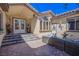 Welcoming courtyard with seating area and double front doors at 8965 S Tenaya Way, Las Vegas, NV 89113