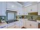 Bright kitchen with white cabinets and a mosaic tile backsplash at 8965 S Tenaya Way, Las Vegas, NV 89113