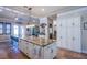 Island kitchen with granite countertop and white cabinets at 8965 S Tenaya Way, Las Vegas, NV 89113