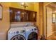 Laundry room with washer, dryer, and cabinets at 8965 S Tenaya Way, Las Vegas, NV 89113