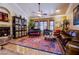 Large living room featuring a fireplace, piano, and ample seating at 8965 S Tenaya Way, Las Vegas, NV 89113