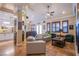 Open living space with light beige couches and a view into the kitchen at 8965 S Tenaya Way, Las Vegas, NV 89113