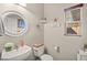 Charming half bathroom with white vanity, toilet, and beach-themed decor at 9124 Ironstone Ave, Las Vegas, NV 89143