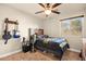 Bedroom with a ceiling fan, window, and guitar wall mount at 9124 Ironstone Ave, Las Vegas, NV 89143