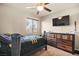 Bedroom with a ceiling fan, large TV, and dresser at 9124 Ironstone Ave, Las Vegas, NV 89143