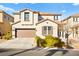 Two-story house with a tan exterior, brown garage door, and landscaping at 9124 Ironstone Ave, Las Vegas, NV 89143