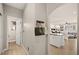 Well-lit hallway with wood-look flooring and access to other rooms at 9124 Ironstone Ave, Las Vegas, NV 89143