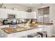 Spacious kitchen with granite island, stainless steel appliances, and white cabinets at 9124 Ironstone Ave, Las Vegas, NV 89143