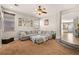 Bright living room with a large sectional sofa and neutral color palette at 9124 Ironstone Ave, Las Vegas, NV 89143