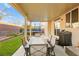 Covered patio with dining table and built-in grill at 9124 Ironstone Ave, Las Vegas, NV 89143