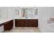 Double vanity bathroom with dark wood cabinets and tile floor at 9221 Black Lake Pl, Las Vegas, NV 89178