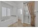 Bathroom with soaking tub, shower, and tile floor at 9221 Black Lake Pl, Las Vegas, NV 89178