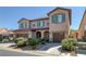 Two-story house with brown garage doors and green shutters at 9221 Black Lake Pl, Las Vegas, NV 89178