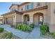 Two-story house with brown garage door and walkway at 9221 Black Lake Pl, Las Vegas, NV 89178