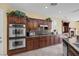 Bright kitchen featuring stainless steel appliances and dark wood cabinets at 9221 Black Lake Pl, Las Vegas, NV 89178