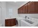 Laundry room with washer, dryer, and cabinets at 9221 Black Lake Pl, Las Vegas, NV 89178