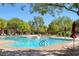 Inviting community pool with lounge chairs and umbrellas at 9221 Black Lake Pl, Las Vegas, NV 89178