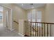 Upstairs hall with carpet and railing at 9221 Black Lake Pl, Las Vegas, NV 89178