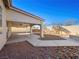 Landscaped backyard with a covered patio and pathway at 9307 Bondeno St, Las Vegas, NV 89123