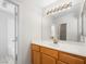 Bathroom with single vanity and a view into a bathtub area at 9307 Bondeno St, Las Vegas, NV 89123