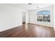 Bedroom with large window, dark laminate flooring, and a closet at 9307 Bondeno St, Las Vegas, NV 89123