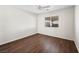 Simple bedroom with dark laminate floors and ceiling fan at 9307 Bondeno St, Las Vegas, NV 89123