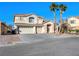 Two-story house with three-car garage and palm trees at 9307 Bondeno St, Las Vegas, NV 89123