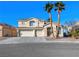 Two-story house with three-car garage and desert landscaping at 9307 Bondeno St, Las Vegas, NV 89123