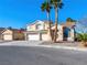 Two-story house with three-car garage and desert landscaping at 9307 Bondeno St, Las Vegas, NV 89123