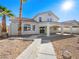 Two-story house with a covered patio and desert landscaping at 9307 Bondeno St, Las Vegas, NV 89123