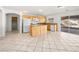 Kitchen with island, wood cabinets, and tiled floors at 9307 Bondeno St, Las Vegas, NV 89123