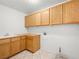 Laundry room with wood cabinets and tiled floor at 9307 Bondeno St, Las Vegas, NV 89123