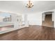 Living room with hardwood floors, chandelier, and staircase at 9307 Bondeno St, Las Vegas, NV 89123