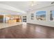 Bright living area with kitchen and backyard access, showcasing laminate floors at 9307 Bondeno St, Las Vegas, NV 89123