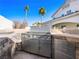 Stainless steel outdoor kitchen with a built-in grill at 9307 Bondeno St, Las Vegas, NV 89123