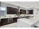 Spacious kitchen featuring dark cabinetry, marble countertops, and high-end appliances at 103 San Martino Pl, Henderson, NV 89011