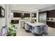 Modern kitchen with dark cabinetry, large island, and stainless steel appliances at 103 San Martino Pl, Henderson, NV 89011