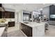 Gourmet kitchen boasts a large island, marble countertops, and dark wood cabinets at 103 San Martino Pl, Henderson, NV 89011