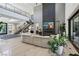 Modern living area with curved sectional sofa and a dramatic fireplace at 103 San Martino Pl, Henderson, NV 89011
