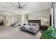 Large main bedroom with sitting area, a ceiling fan, and lots of natural light at 103 San Martino Pl, Henderson, NV 89011