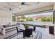 Covered patio with outdoor seating and pool access at 103 San Martino Pl, Henderson, NV 89011