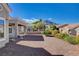 A landscaped backyard featuring desert landscaping, covered patio and scenic mountain views under a sunny sky at 10300 Bent Brook Pl, Las Vegas, NV 89134