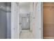 Hallway featuring access to bathroom with tiled glass shower enclosure and built-in storage at 10300 Bent Brook Pl, Las Vegas, NV 89134