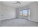 Inviting bedroom featuring soft carpet, neutral walls, ceiling fan and multiple windows offering ample light at 10300 Bent Brook Pl, Las Vegas, NV 89134